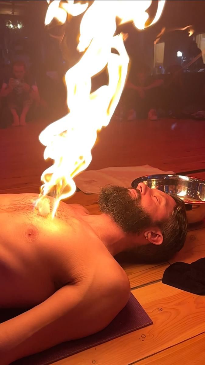 Internal Ignition ceremony: a fire bubble burning over a man's heart as he lies peacefully