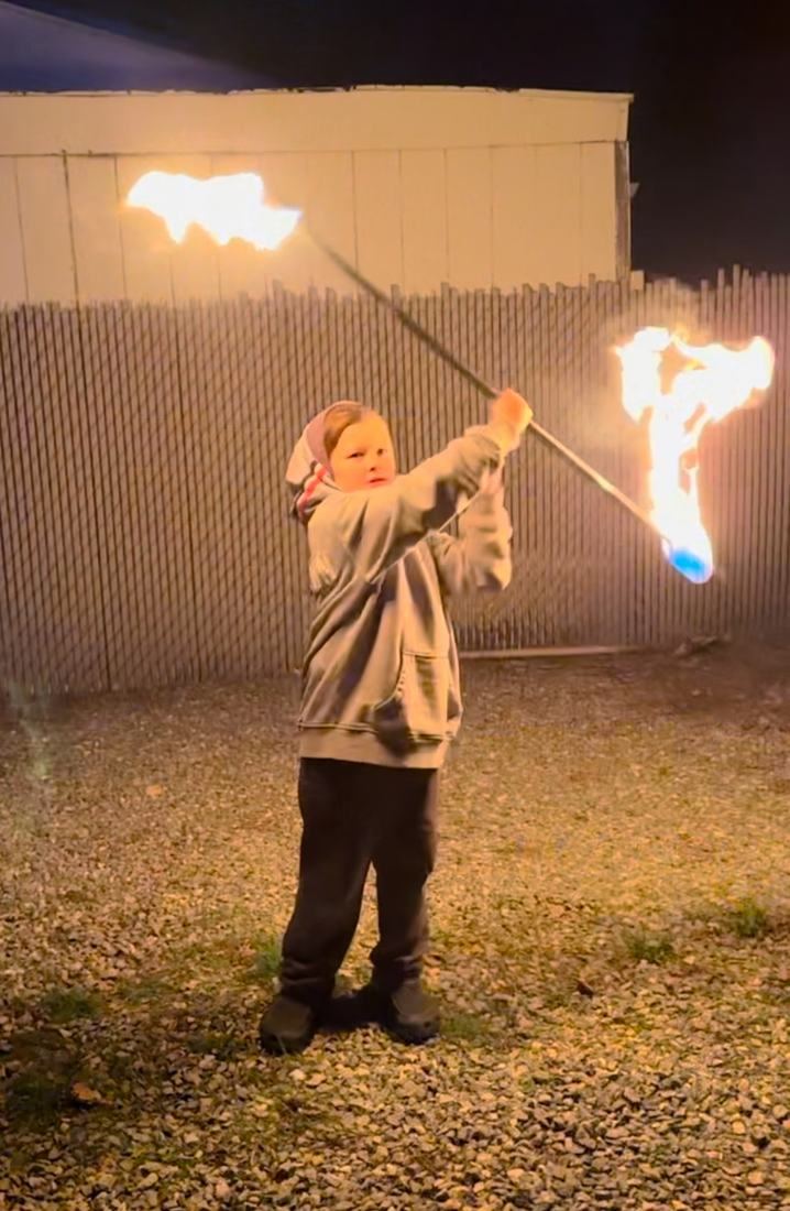 Tyler's son spinning a fire staff